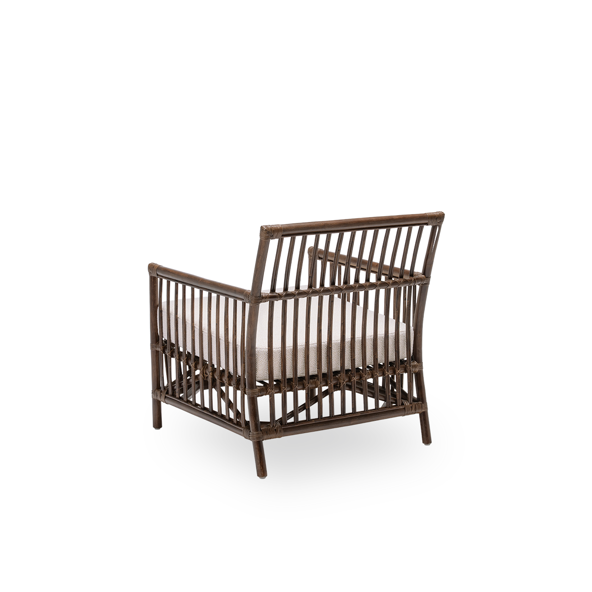 Back side view of the Caroline lounge chair with seat cushion, in brown rattan. A simple and elegant Danish design whose detailed windings make it a quiet element in the room. Handcrafted from high-quality Indonesian rattan.