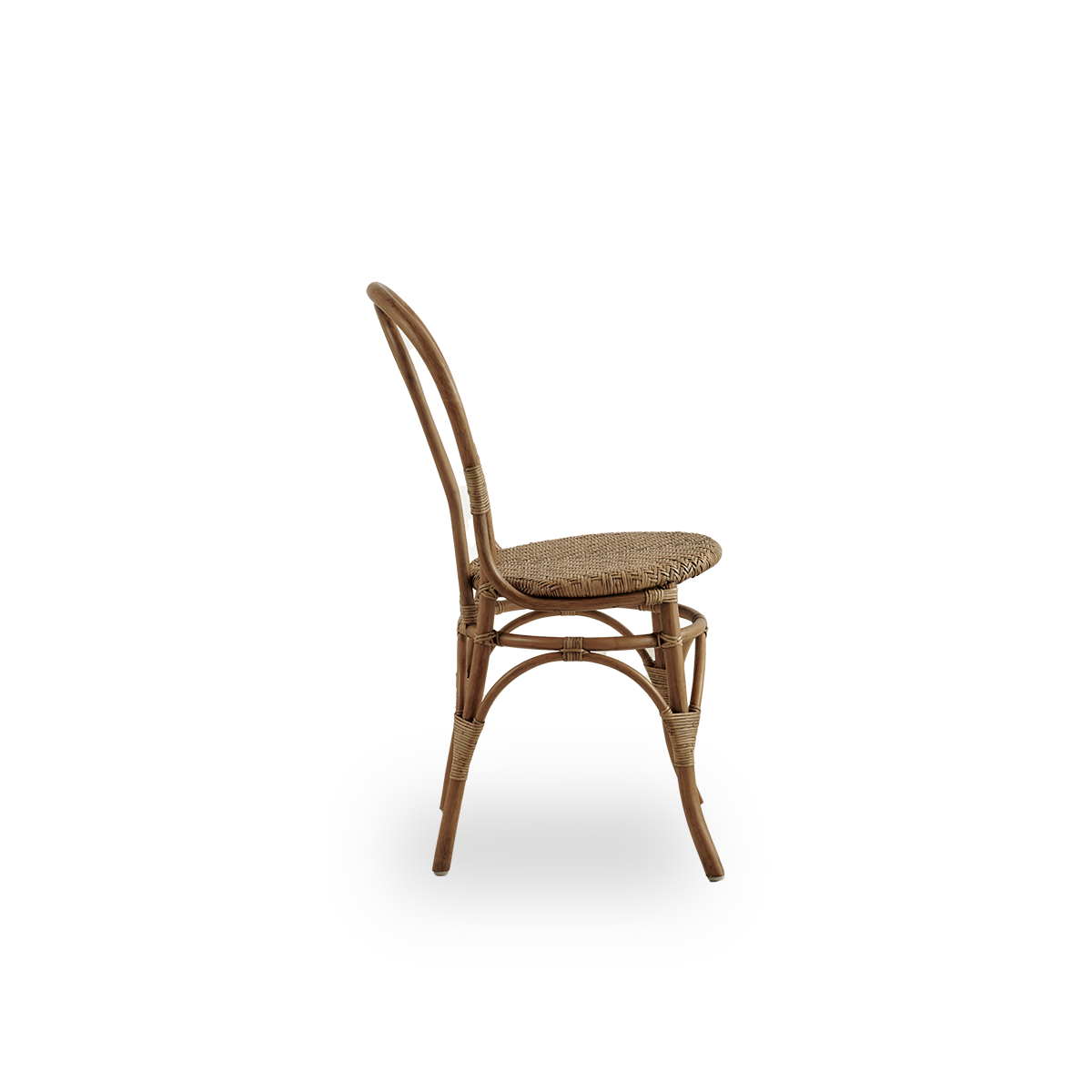 Plain side view of Lulu dining chair in Antique brown color, handcrafted from high-quality Indonesian rattan. Lightweight, elegant design with round simple backrest.