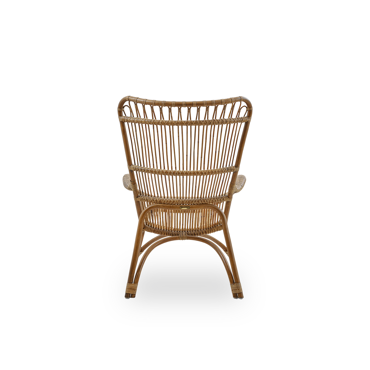 Plain back view of Monet lounge chair with high backrest and armrests presented in Antique brown color. Handcrafted from high-quality Indonesian rattan.