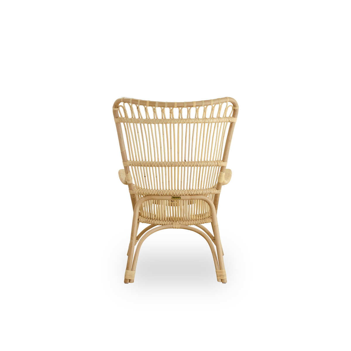 Plain back view of Monet lounge chair with high backrest and armrests presented in natural rattan. Handcrafted from high-quality Indonesian rattan.