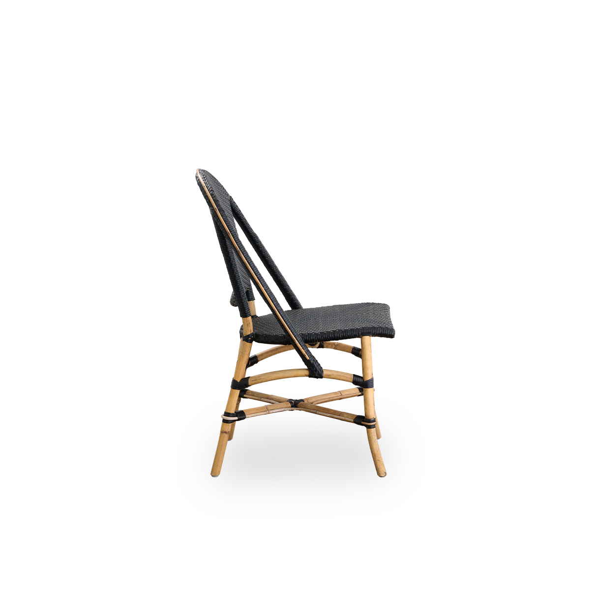 Plain side view of Sofie rattan dining chair inspired by French café style. Rattan frame with fully woven seat- and backrest handcrafted in ArtFibre in black color. Stackable rattan bistro chair.