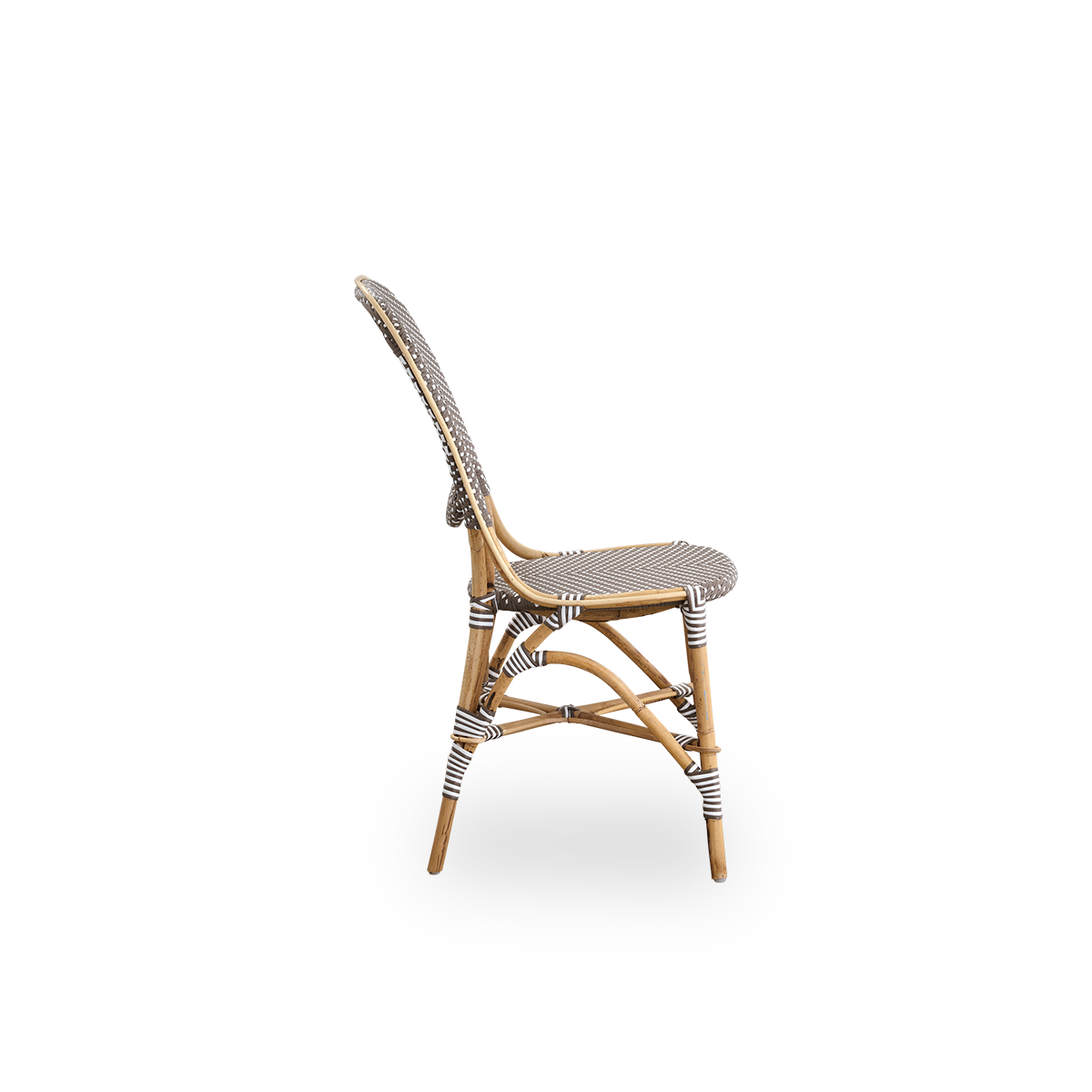Plain side view of Isabell dining chair. Rattan frame with seat and backrest made in brown ArtFibre with white dots. Inspired by 1950s bistro design.
