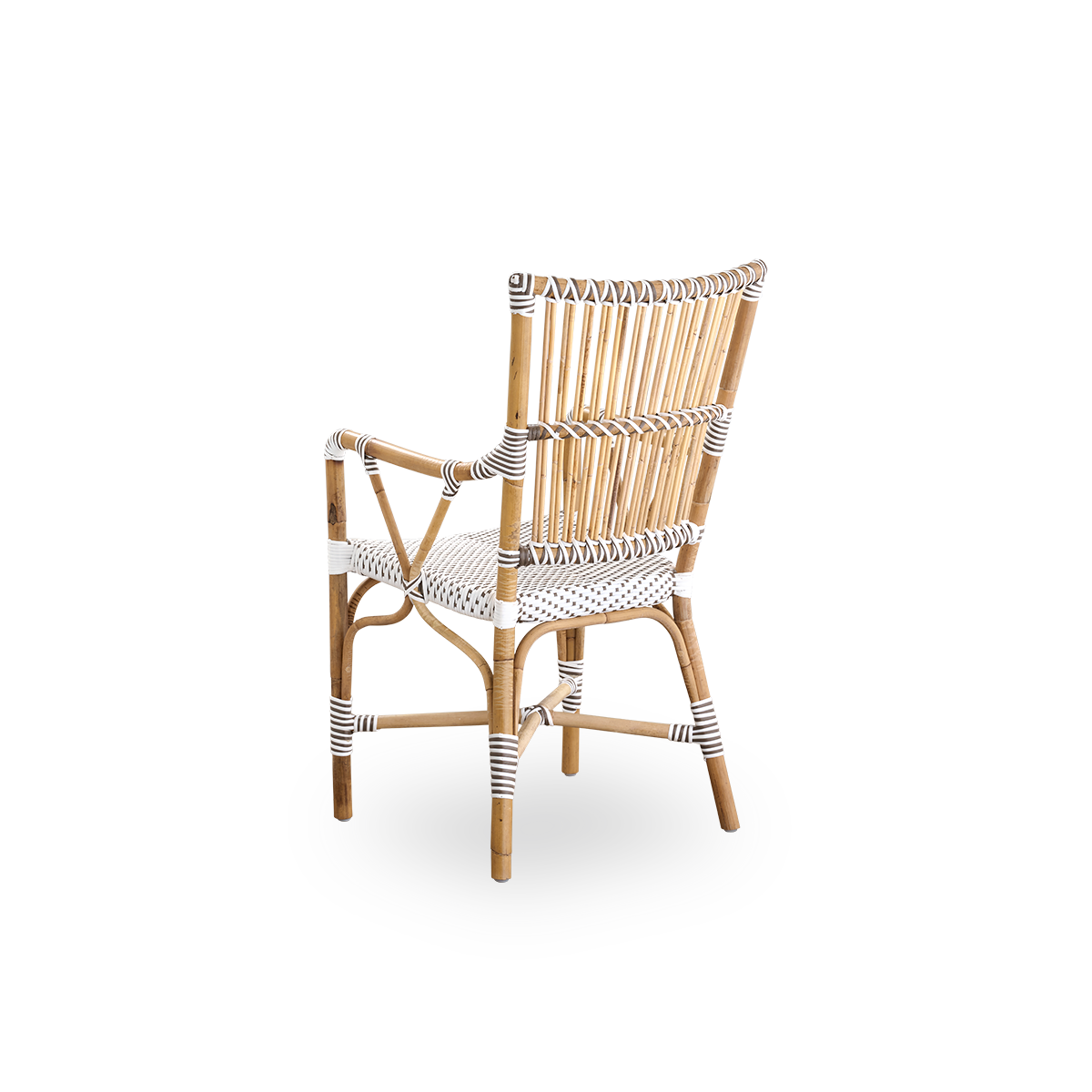 Back side view of the Monique dining armchair.
Rattan frame with seat woven with ArtFibre in white with brown dots. Inspired by 1950s bistro design.