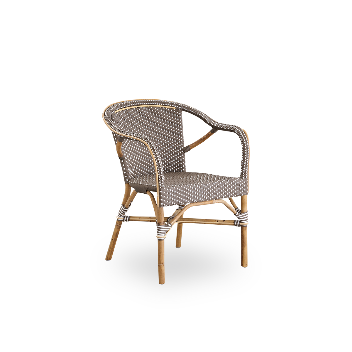 Side view of Madeleine dining armchair. Rattan frame with seat and backrest woven with ArtFibre in brown with white dots. Inspired by 1950s bistro design.