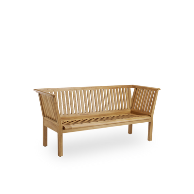 Side view of St Catherine outdoor teak bench designed by Arne Jacobsen, length 180 cm. Solid and durable bench handcrafted in chestnut brown high quality Indonesian teakwood certified ‘Indonesian Legal Wood’
