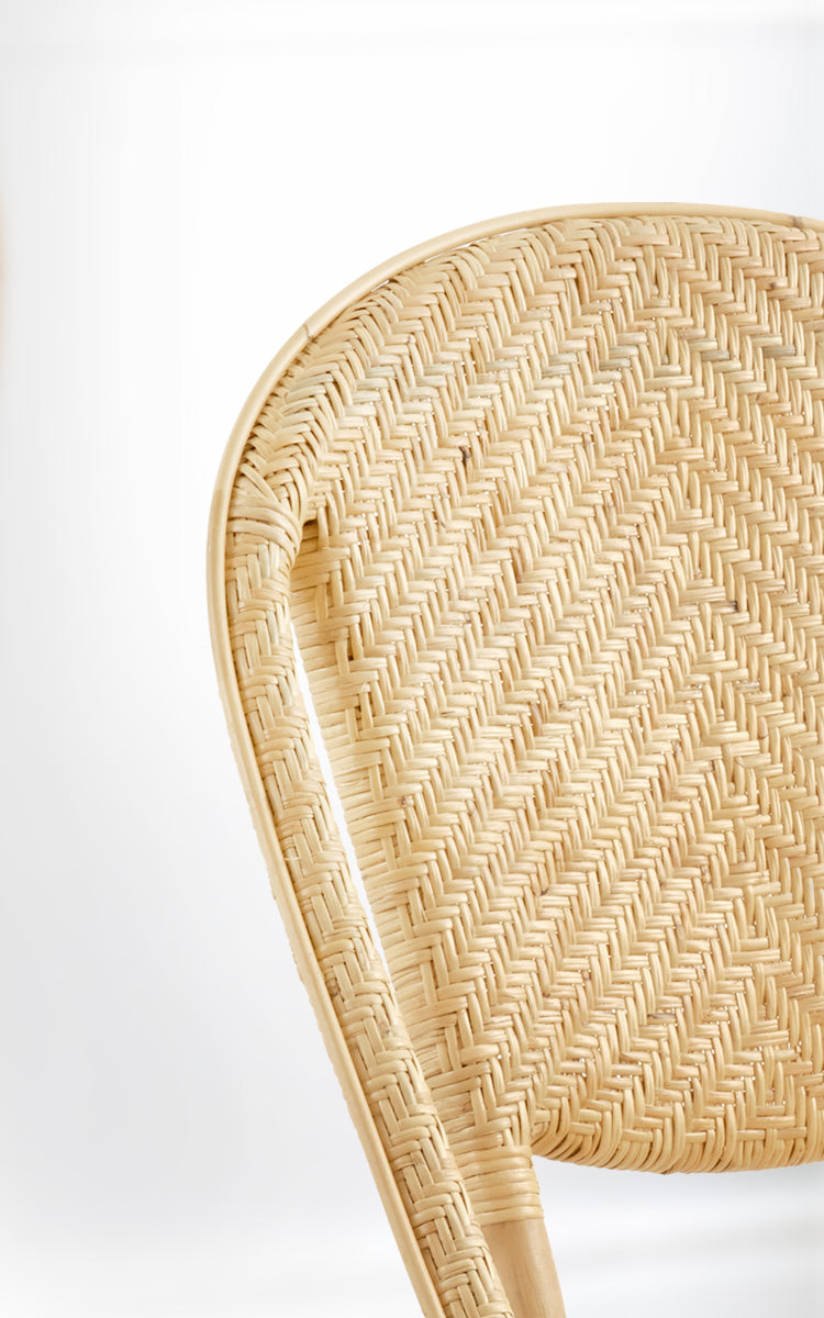 This is a close-up image of Alanis Dining Chair in natural rattan.