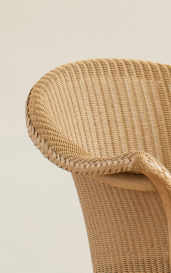 This is a close-up image of Classic Dining Chair in natural Loom Rattan Frame.