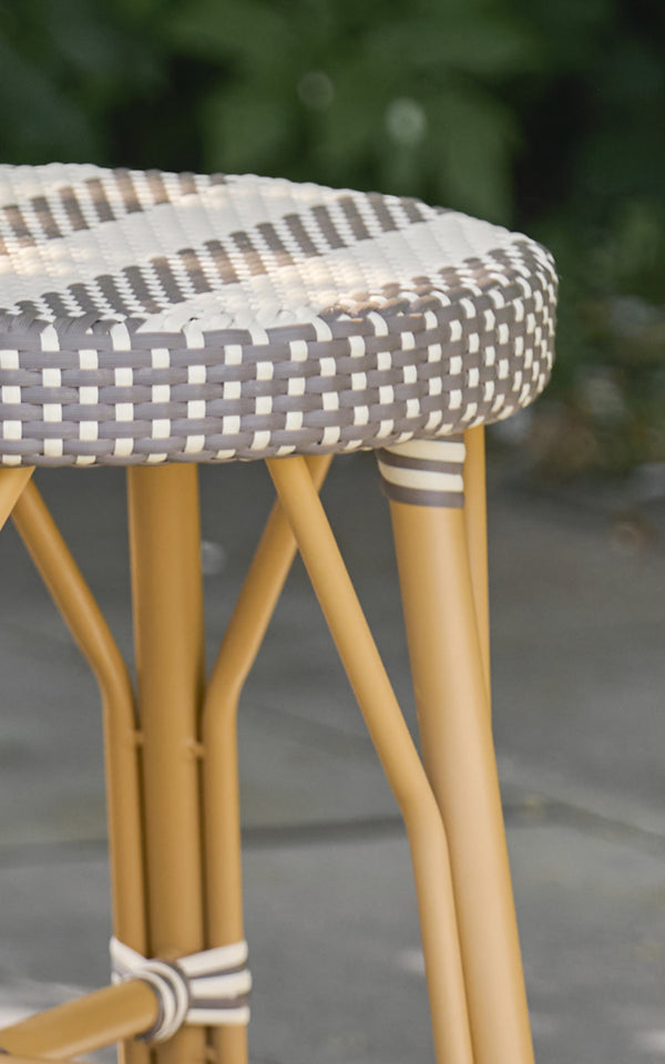 This is a close-up image of Simone Exterior Stool in almond aluminium frame striped cappuccino ivory artfibre.