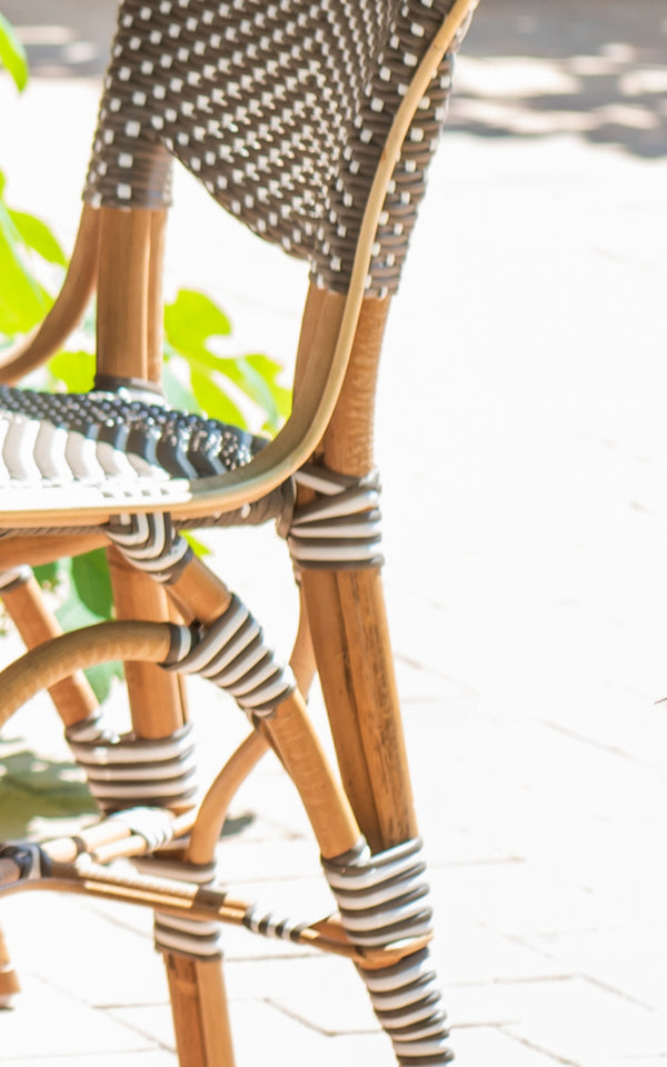 This is a close-up image of Isabell in cappuccino w white dot ArtFibre skin on rattan frame.