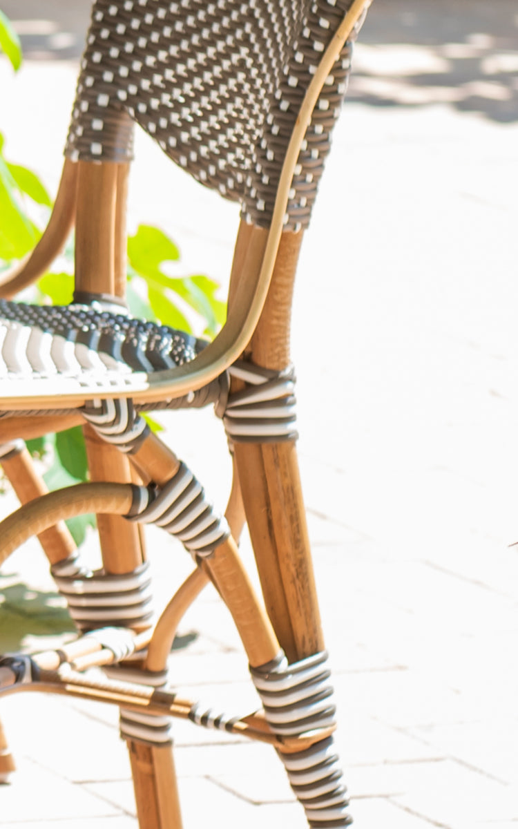 This is a close-up image of Isabell in cappuccino w white dot ArtFibre skin on rattan frame.
