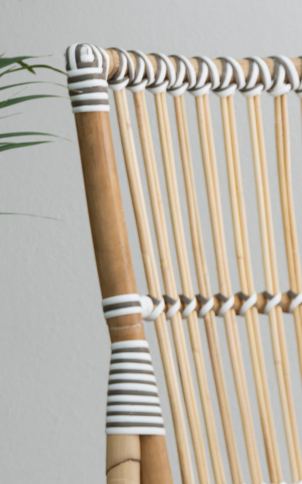 This is a close-up image of Monique Dining Chair in white w cappuccino dot artfibre skin on rattan frame.