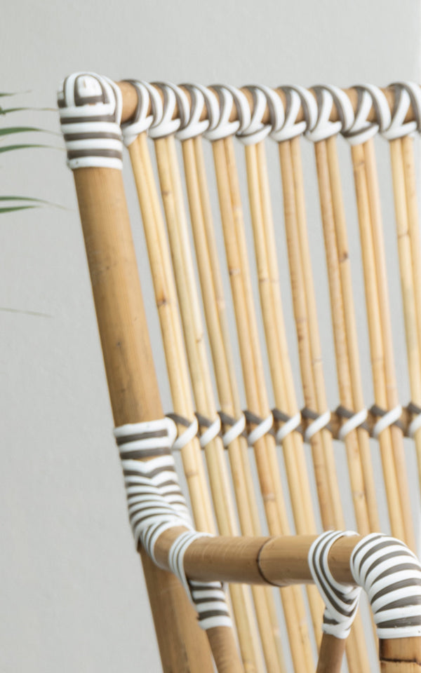 This is a close-up image of Monique Dining Armchair in white w cappuccino dot artfibre skin on rattan frame.