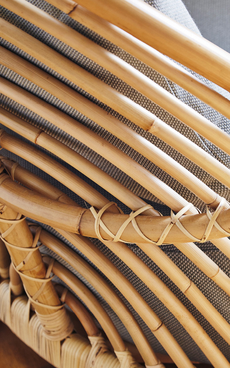 This is a close-up image of Charlottenborg Lounge Chair in polished Natural Rattan.