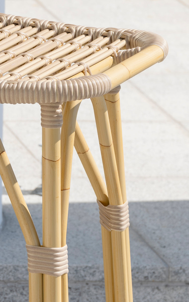 This is a close-up image of Salsa Exterior Bar Stool in natural aluminium artfibre. Tall legs with wrapped joints and open weave seat detail.