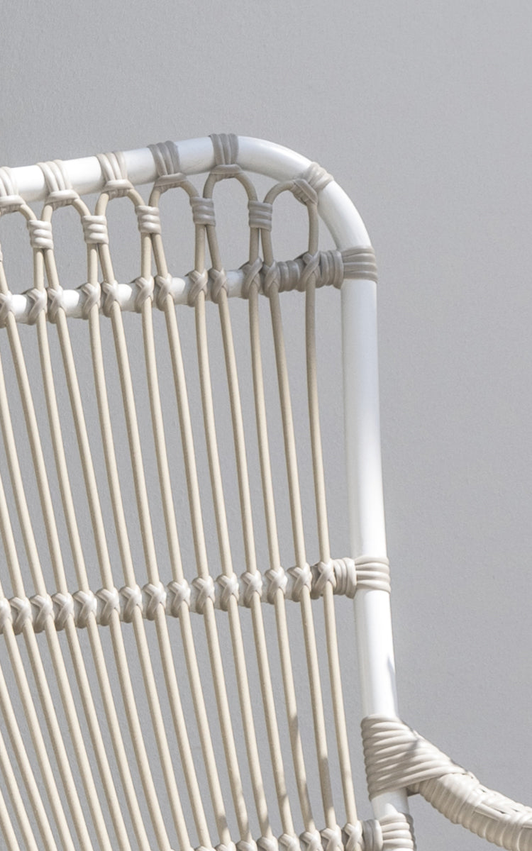 This is a close-up image of Monet Exterior Lounge Chair in dove white aluminium artfibre. Detail of the looped arch design.