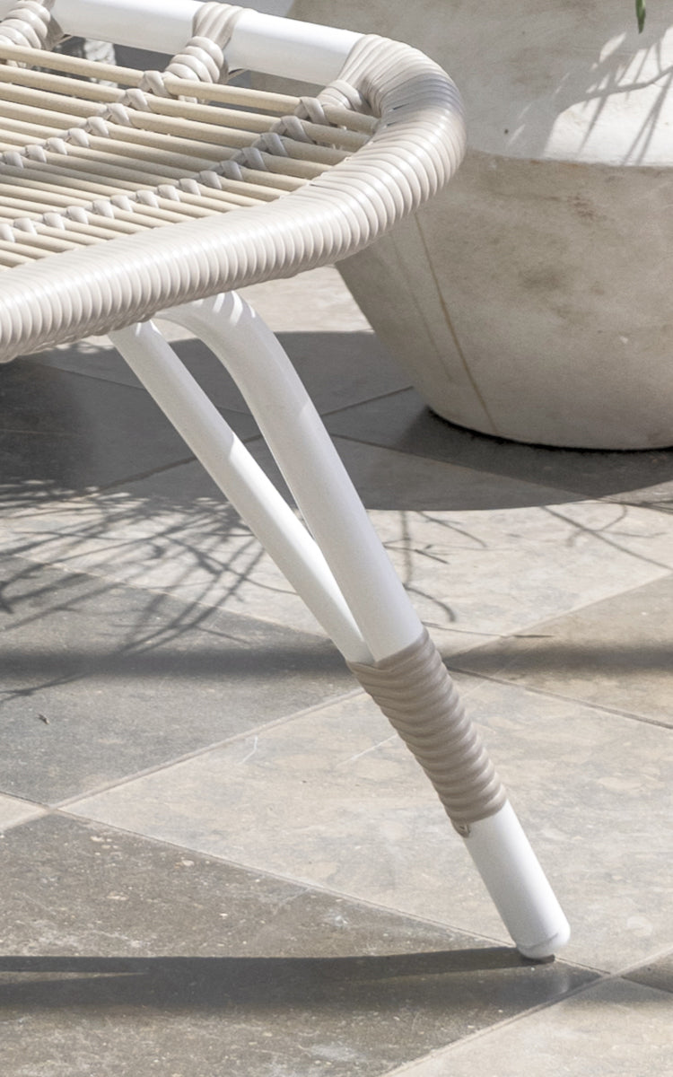 This is a close-up image of Monet Exterior Footstool in dove white aluminium artfibre. Detail of the woven seat and white frame.