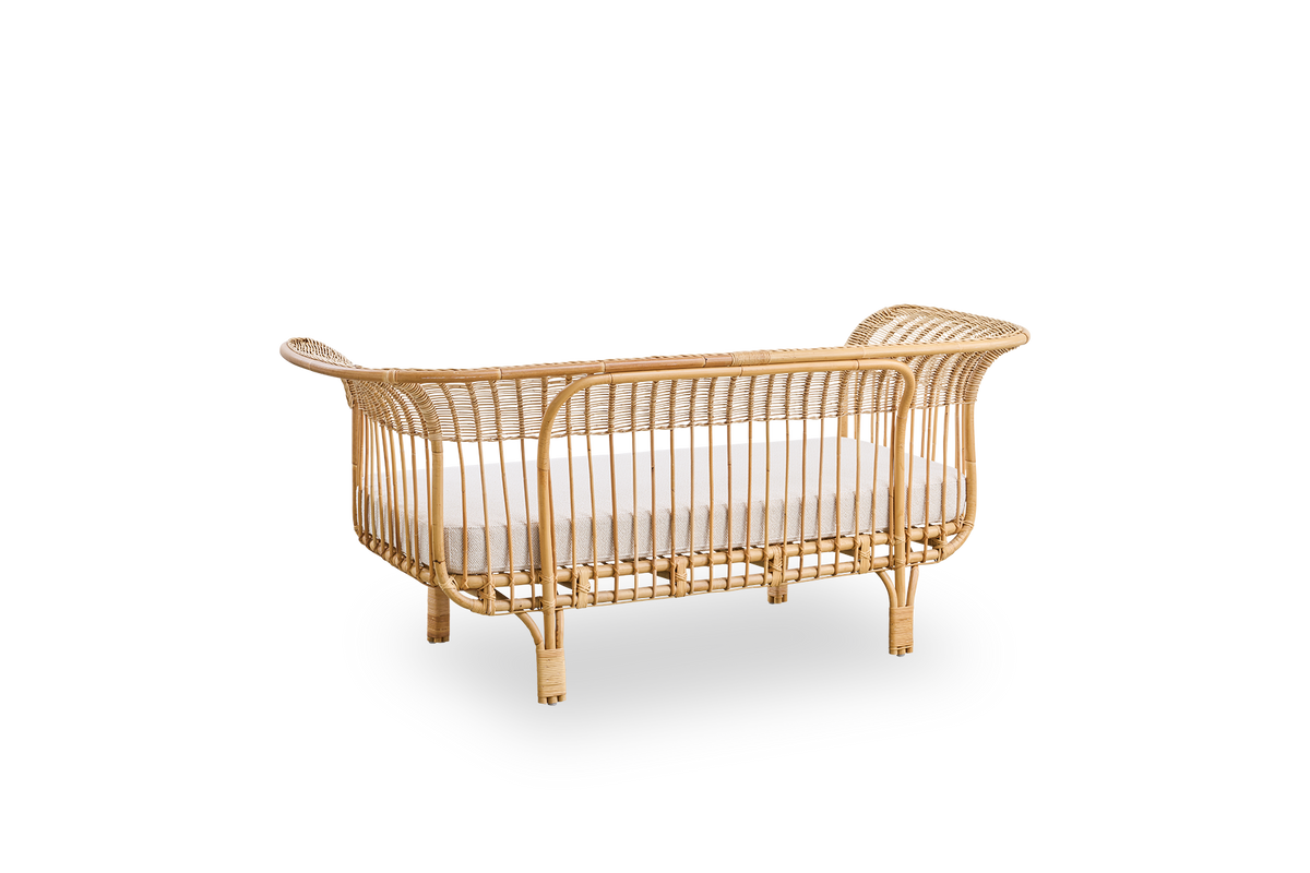 Back side view of Belladonna sofa in natural rattan, designed by Franco Albini and Franca Helg. The sofa has an elegant expression with thin legs and a majestic seat with many detailed windings.