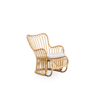 Side view of Tulip lounge chair designed by Tove Kindt-Larsen, with soft organic lines. Handcrafted from high-quality Indonesian rattan