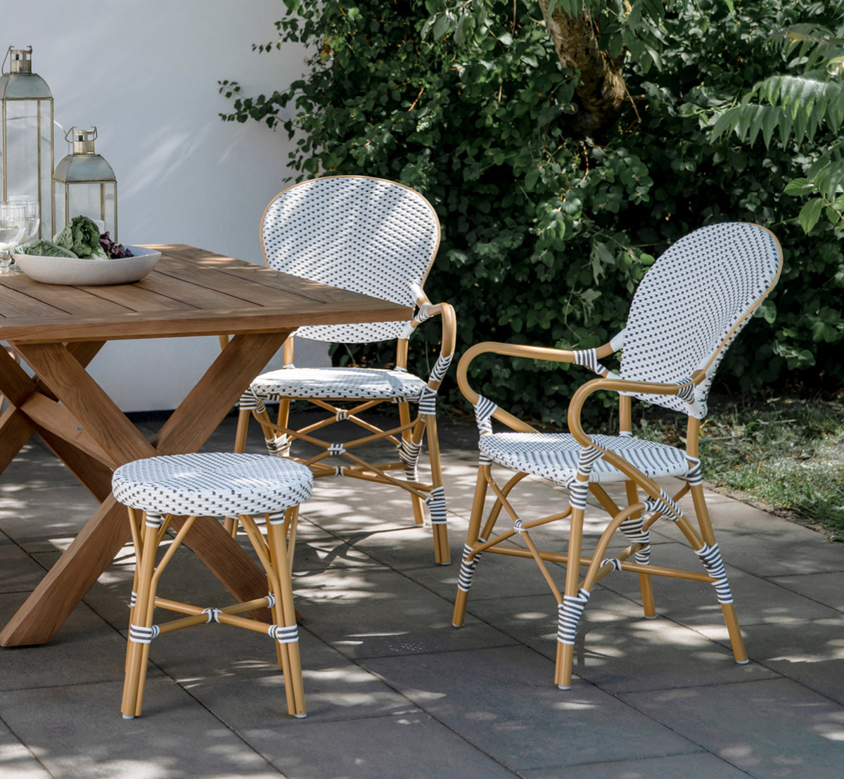 This is a lifestyle image of Simone Exterior Stool in almond aluminium frame white w cappuccino dot artfibre. Styled in a bright interior setting.