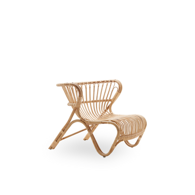Side view of Fox lounge chair in natural rattan color designed by Viggo Boesen. Low curvy wicker lounge chair handcrafted from high-quality Indonesian rattan.