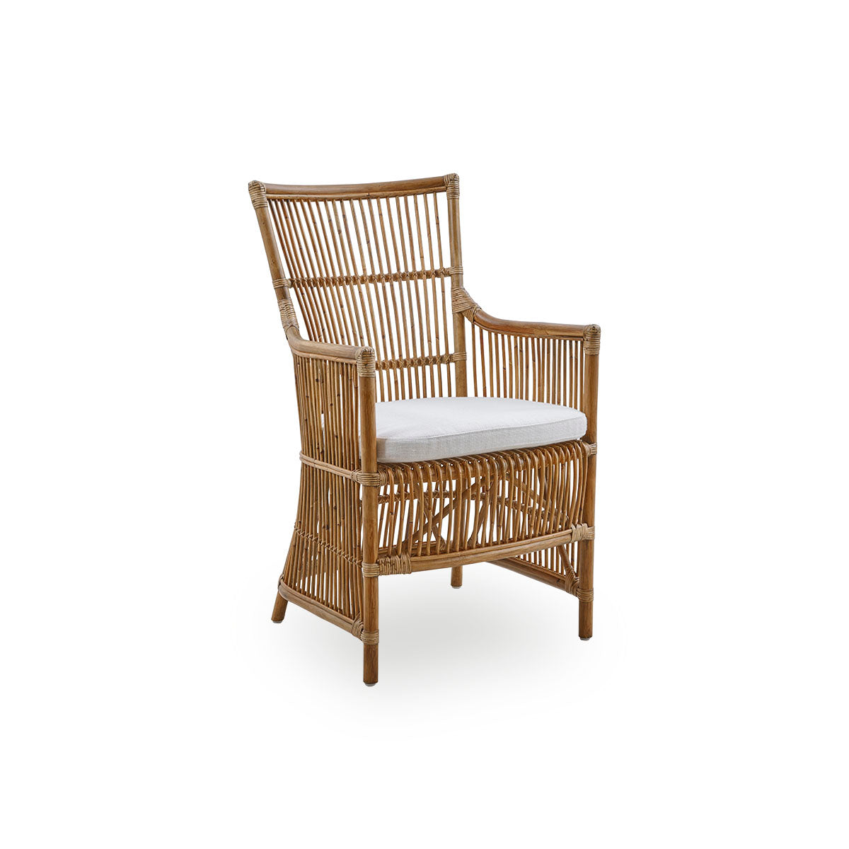 Side view of the Davinci dining chair in antique brown color. A wicker chair with armrests and a high back, handcrafted from high-quality Indonesian rattan.