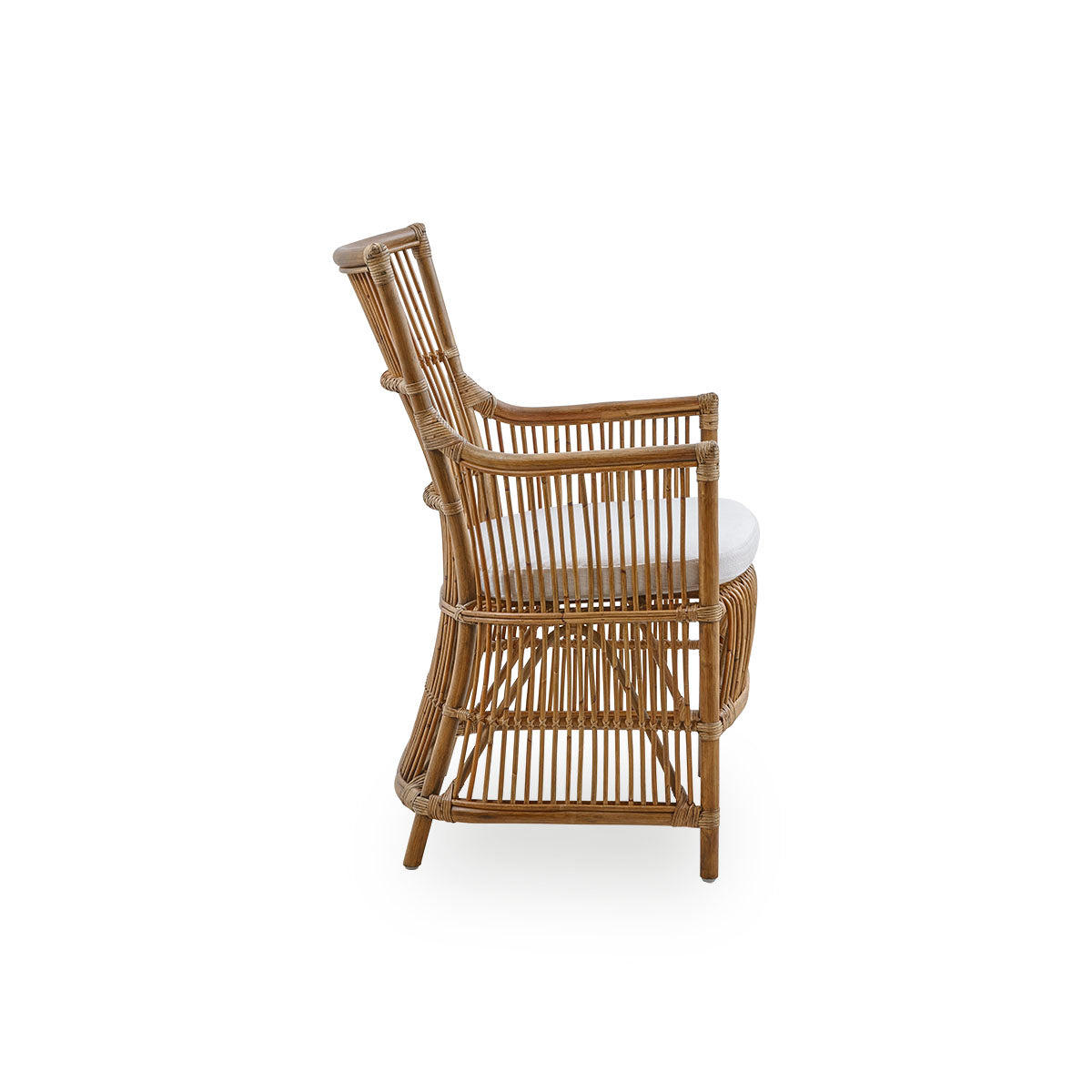 Plain side view of the Davinci dining chair in antique brown color. A wicker chair with armrests and a high back, handcrafted from high-quality Indonesian rattan.