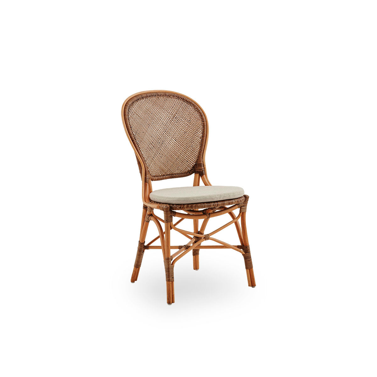 Side view of Rossini dining chair in Cherry color. Elegant wicker chair with round backrest in simple design. Handcrafted from high quality rattan.