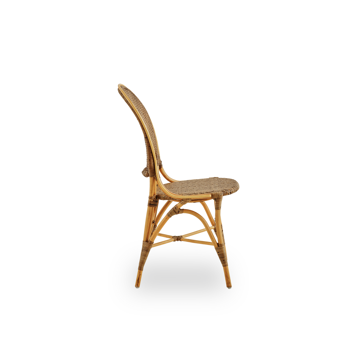 Plain side view of Rossini dining chair in Cherry color. Elegant wicker chair with round backrest in simple design. Handcrafted from high quality rattan.