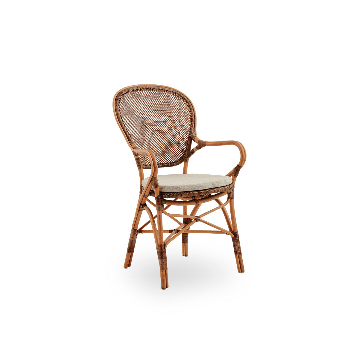 Side view of Rossini dining armchair in Cherry color. Elegant wicker chair with round backrest and armrests in simple design. Handcrafted from high quality rattan.