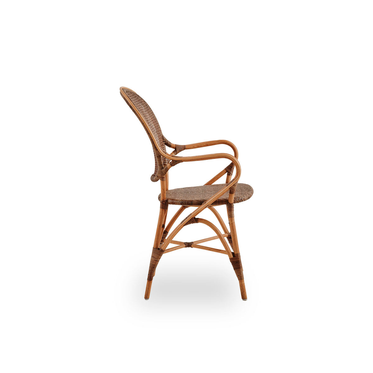 Plain side view of Rossini dining armchair in Cherry color. Elegant wicker chair with round backrest and armrests in simple design. Handcrafted from high quality rattan.