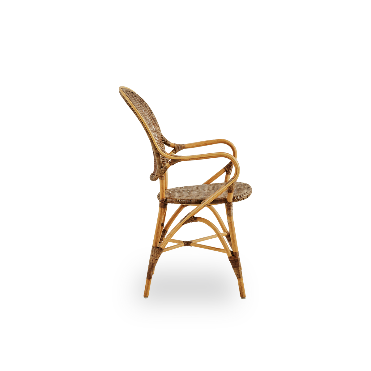 Plain side view of Rossini dining armchair in Cherry color. Elegant wicker chair with round backrest and armrests in simple design. Handcrafted from high quality rattan.