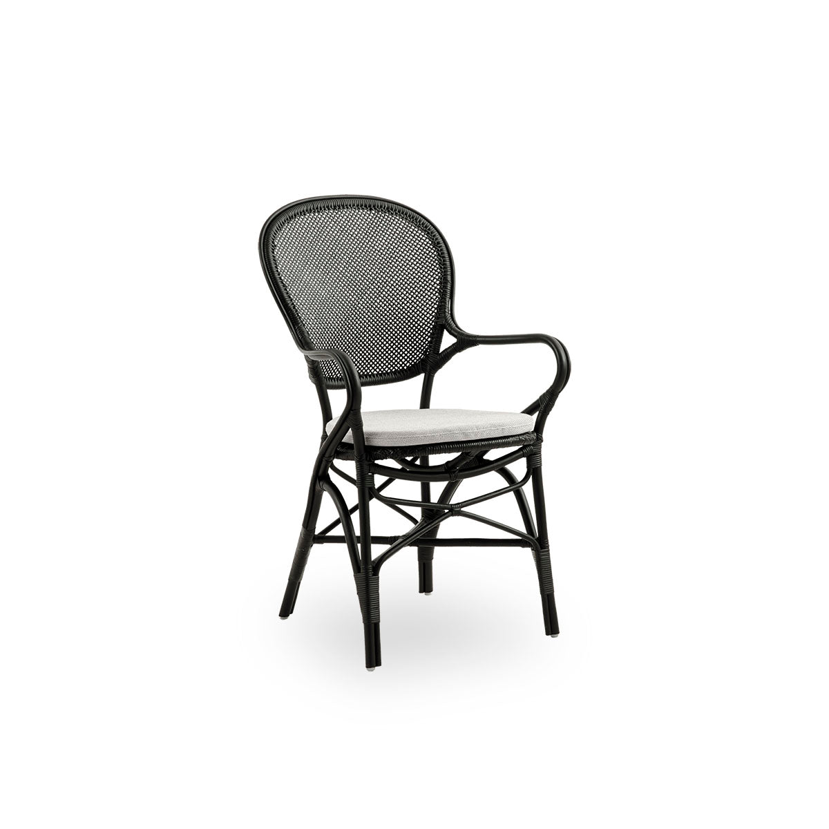 Side view of Rossini dining armchair in black color. Elegant wicker chair with round backrest and armrests in simple design. Handcrafted from high quality rattan.