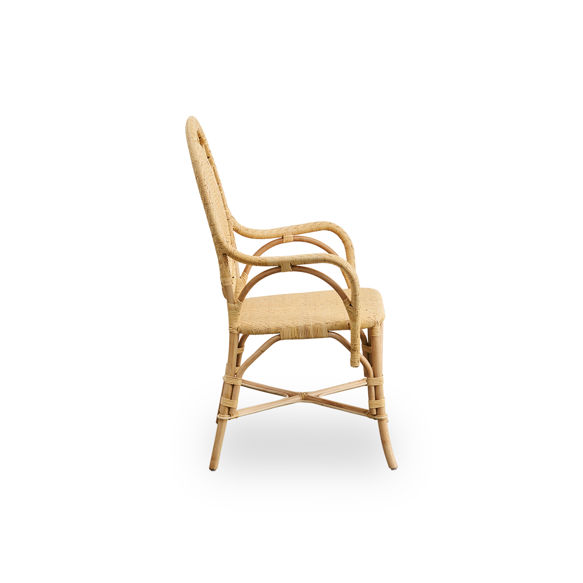 Plain side view of Romantica dining chair in Natural color. Elegant, romantic wicker dining chair with round backrest and fully woven seat in charming Danish design. Handcrafted from high-quality Indonesian rattan.