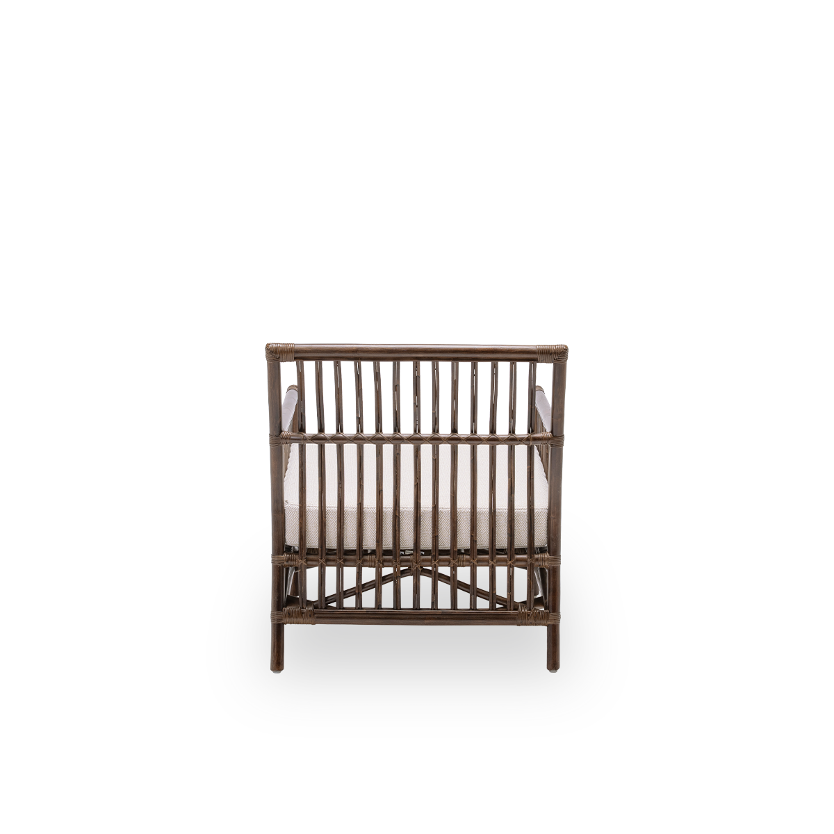 Plain back view of the Caroline lounge chair with seat cushion, in brown rattan. A simple and elegant Danish design whose detailed windings make it a quiet element in the room. Handcrafted from high-quality Indonesian rattan.