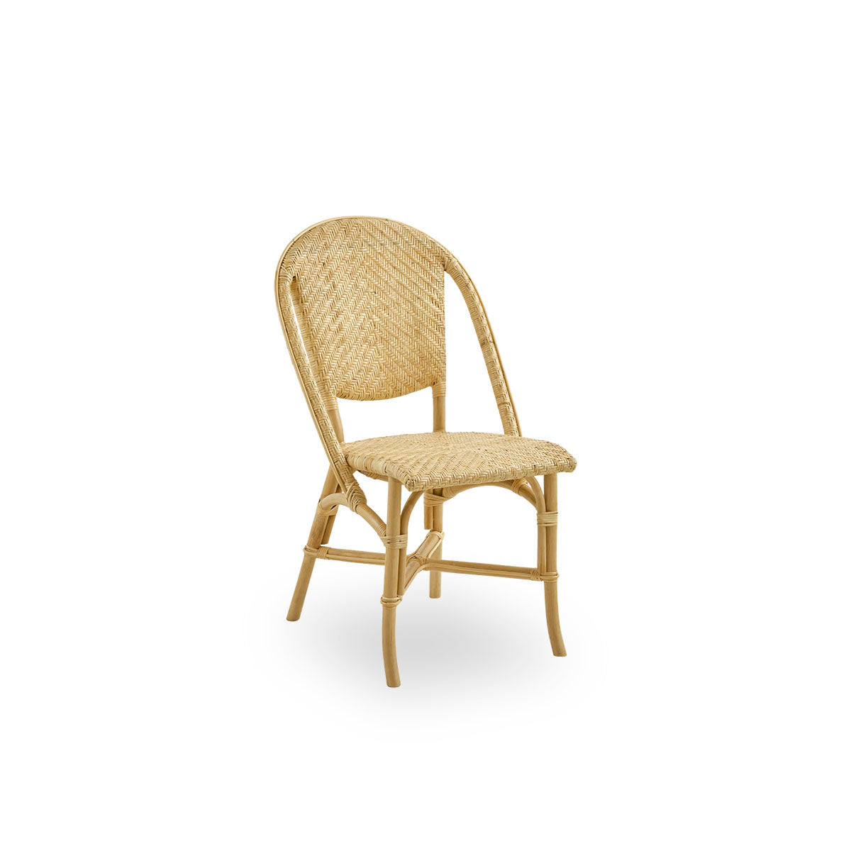 Side view of Alanis dining chair in high quality natural rattan, featuring elegant curves and detailed weaving. 