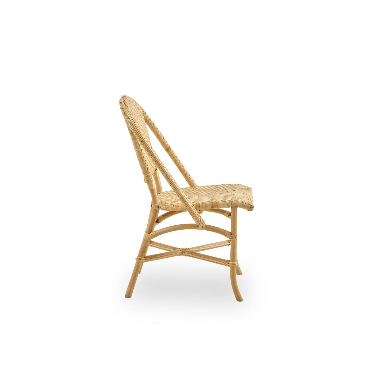 Plain side view of Alanis dining chair in high quality natural rattan, featuring elegant curves and detailed weaving. 