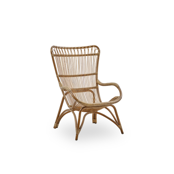 Side view of Monet lounge chair with high backrest and armrests presented in Antique brown color. Handcrafted from high-quality Indonesian rattan.