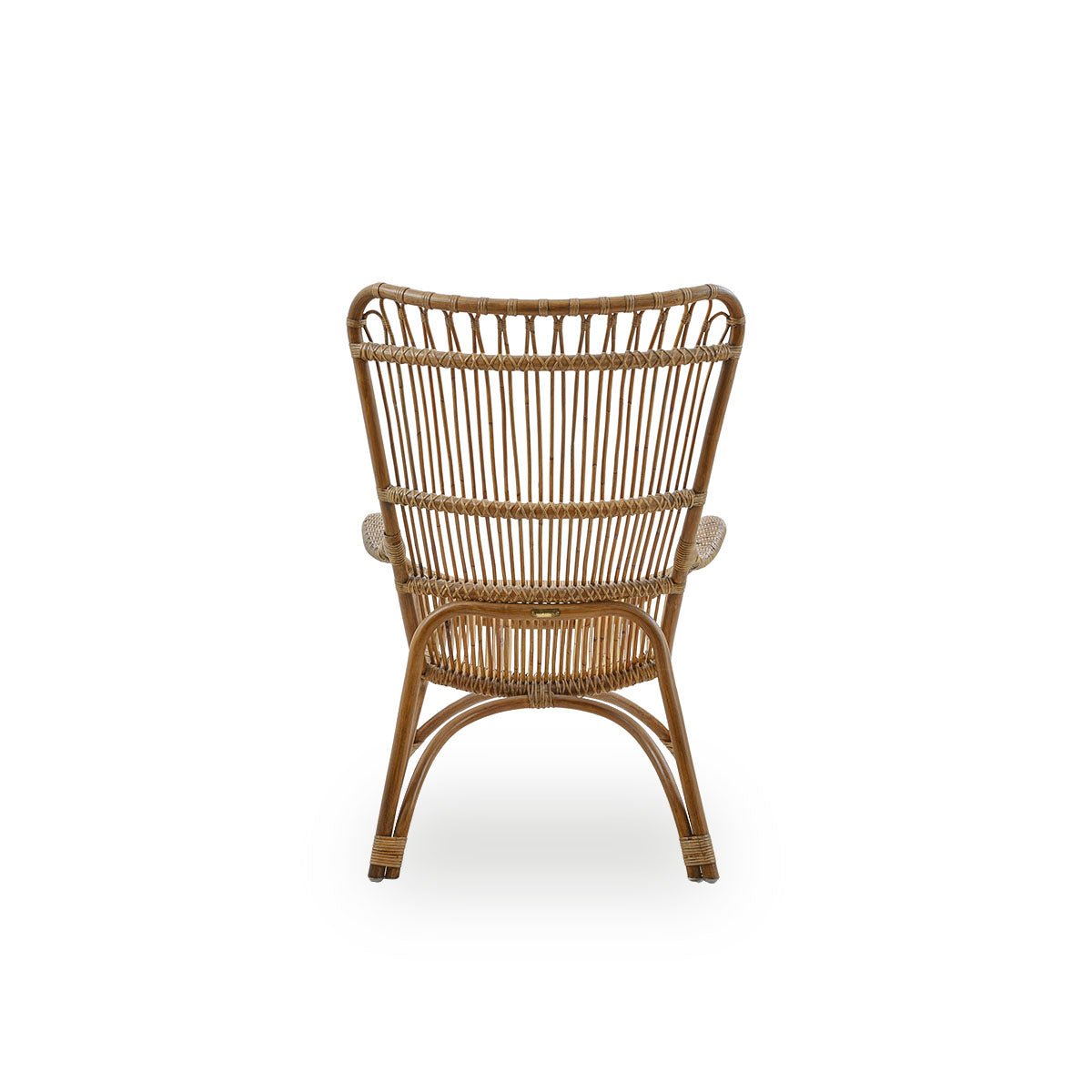 Plain back view of Monet lounge chair with high backrest and armrests presented in Antique brown color. Handcrafted from high-quality Indonesian rattan.