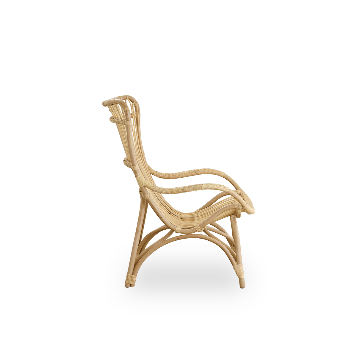 Plain side view of Monet lounge chair with high backrest and armrests presented in natural rattan. Handcrafted from high-quality Indonesian rattan.