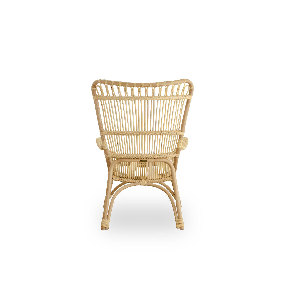 Plain back view of Monet lounge chair with high backrest and armrests presented in natural rattan. Handcrafted from high-quality Indonesian rattan.