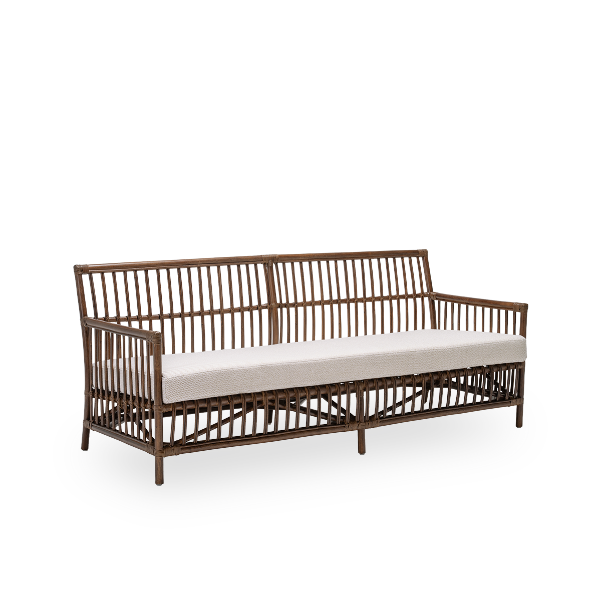 Side view of the Caroline sofa with seat cushion, in brown rattan. A simple and elegant Danish design whose detailed windings make it a quiet element in the room. Handcrafted from high-quality Indonesian rattan.