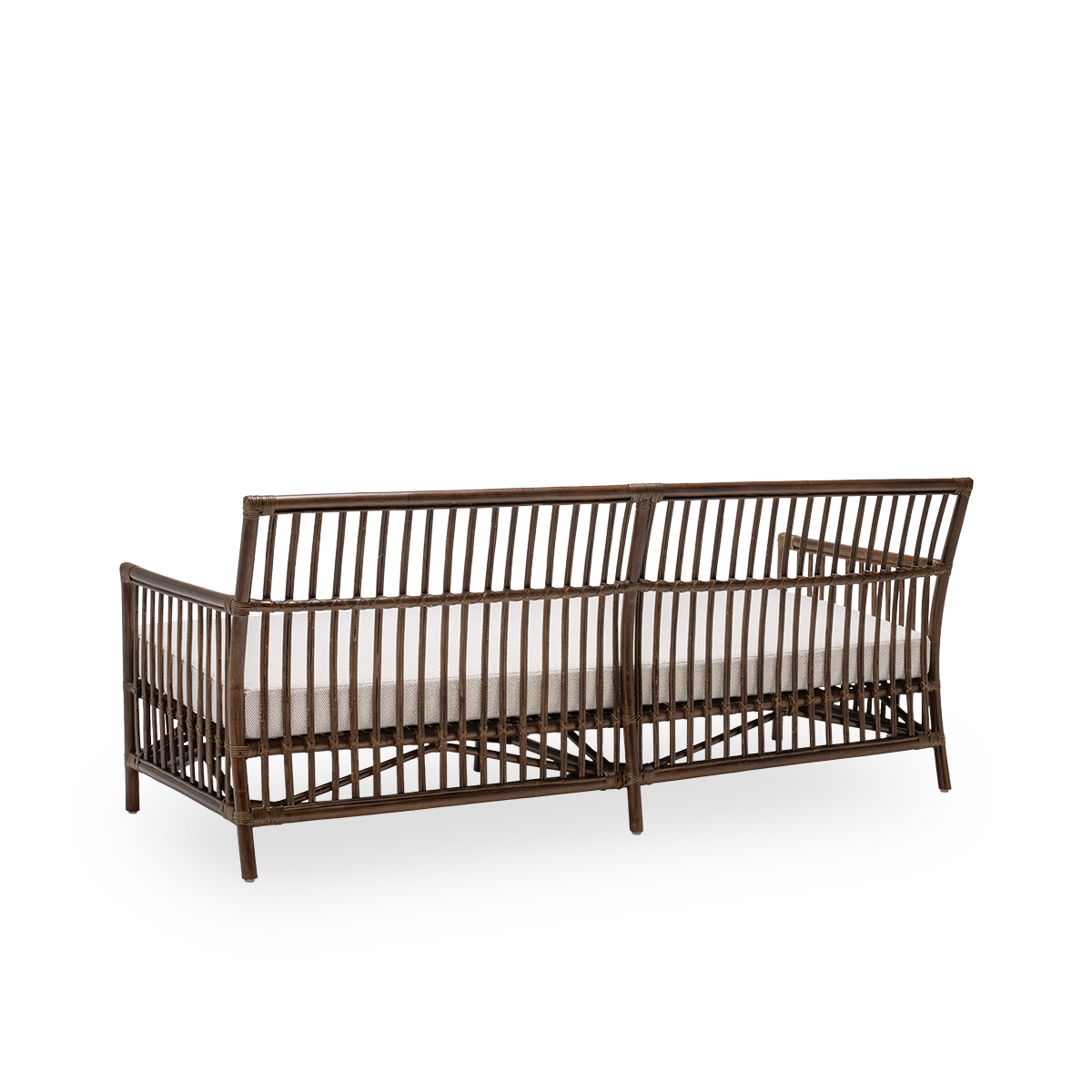 Back side view of the Caroline sofa with seat cushion, in brown rattan. A simple and elegant Danish design whose detailed windings make it a quiet element in the room. Handcrafted from high-quality Indonesian rattan.