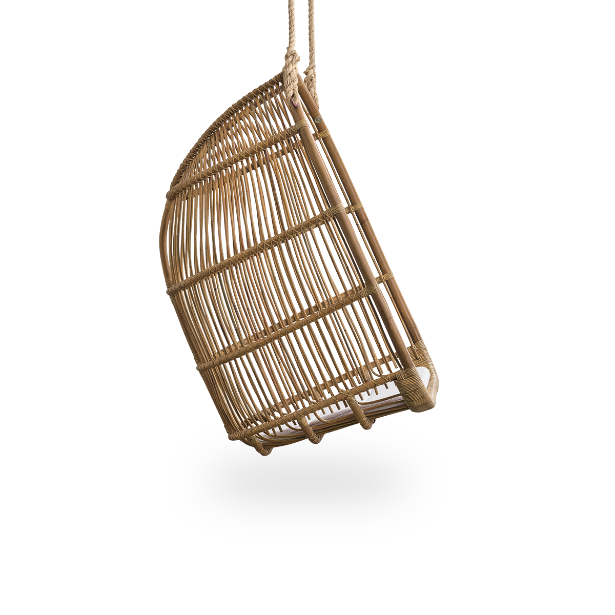 Plain side view of Renoir hanging chair in Antique brown color handcrafted in high quality rattan. Soft, embracing shape suspended with strong rope.