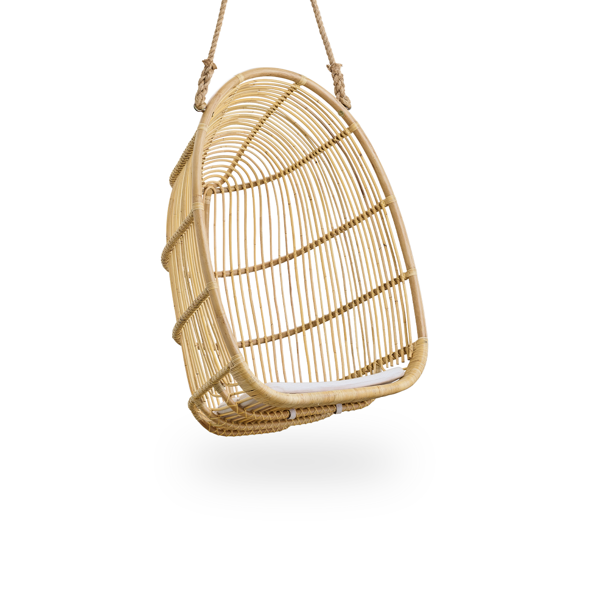 Side view of Renoir hanging chair in Natural color handcrafted in high quality rattan. Soft, embracing shape suspended with strong rope.