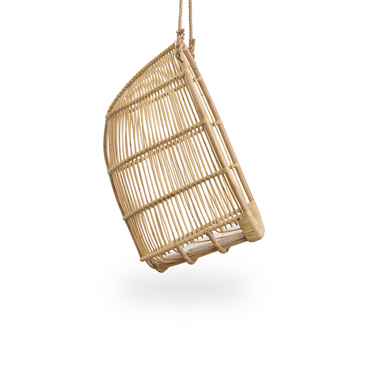 Plain side view of Renoir hanging chair in Natural color handcrafted in high quality rattan. Soft, embracing shape suspended with strong rope.