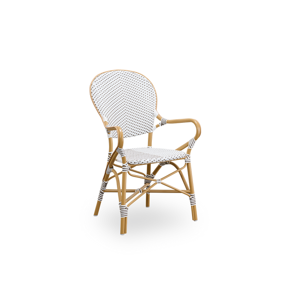 Side view of Isabell outdoor dining armchair. Almond colored aluminium frame with seat and backrest made in white ArtFibre with brown dots. Inspired by 1950s bistro design.