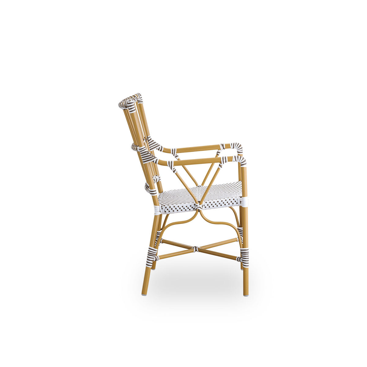 Plain side view of Monique outdoor dining armchair. Aluminium frame in almond color with seat woven with ArtFibre in white with brown dots. Inspired by 1950s bistro design.