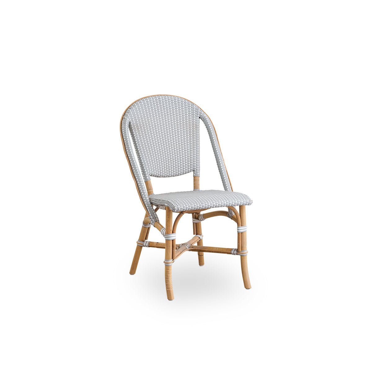 Side view of Sofie rattan dining chair inspired by French café style. Rattan frame with fully woven seat- and backrest handcrafted in ArtFibre in grey with white dots pattern. Stackable rattan bistro chair.