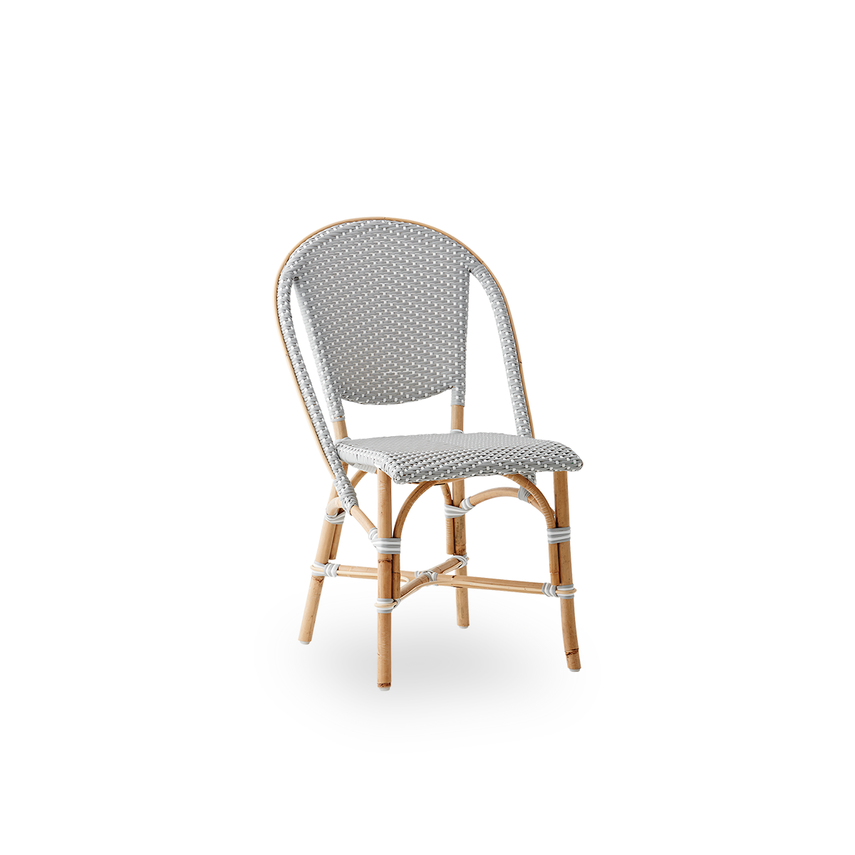 Side view of Sofie rattan dining chair inspired by French café style. Rattan frame with fully woven seat- and backrest handcrafted in ArtFibre in grey with white dots pattern. Stackable rattan bistro chair.