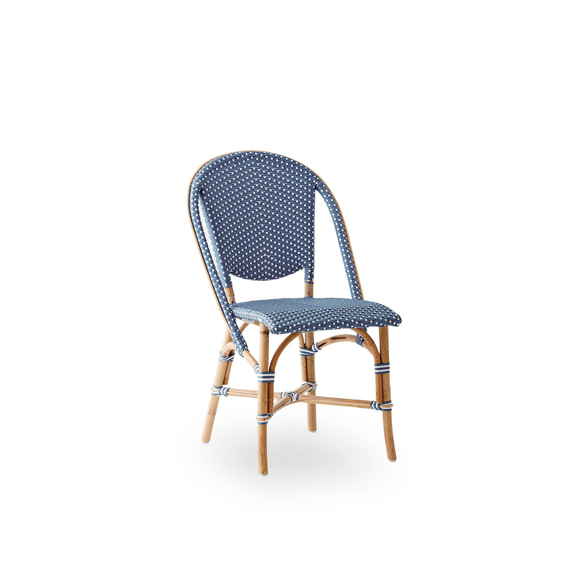Side view of Sofie rattan dining chair inspired by French café style. Rattan frame with fully woven seat- and backrest handcrafted in ArtFibre in blue with white dots pattern. Stackable rattan bistro chair.